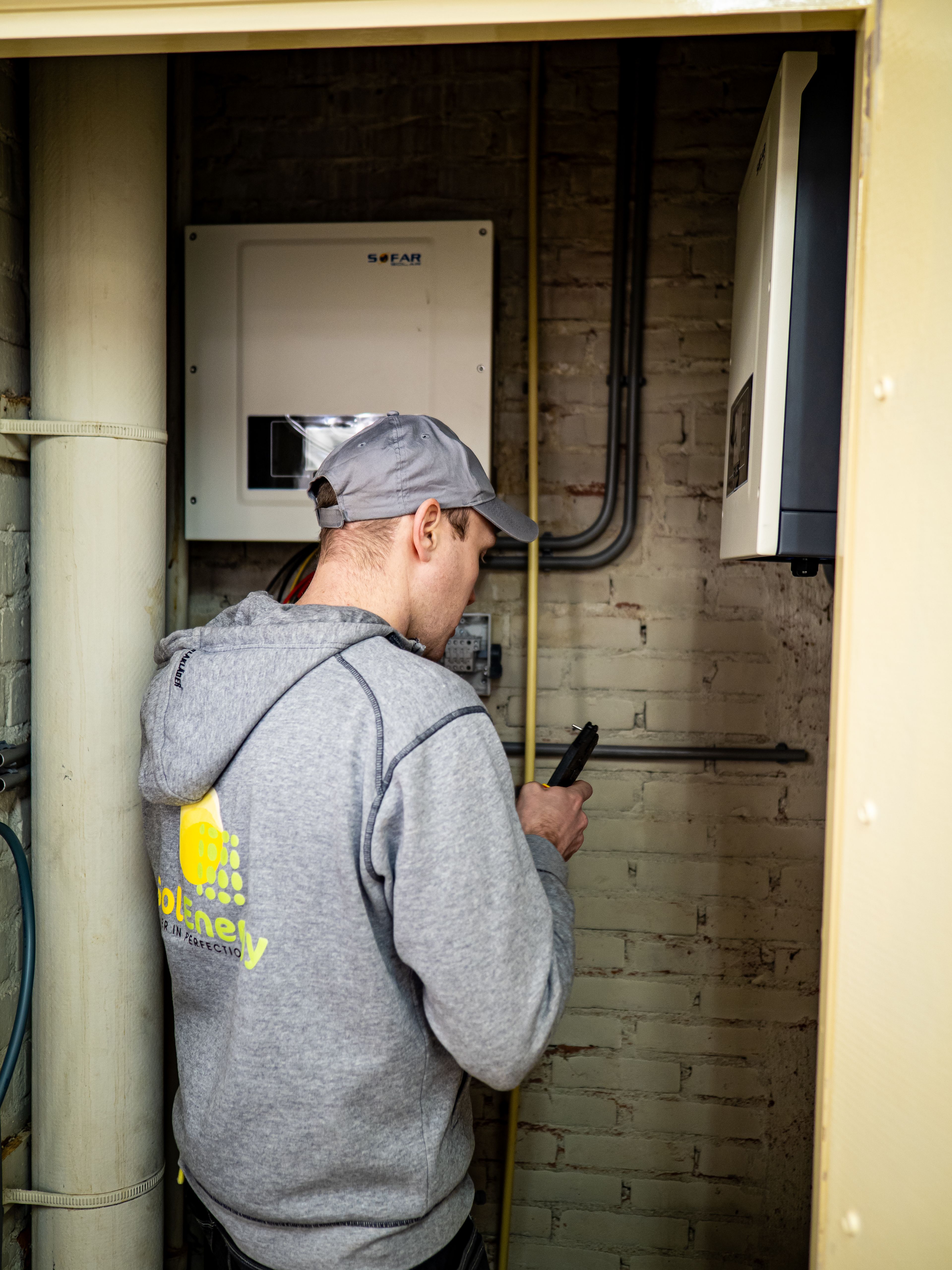 Technician installing inverter backup power equipment