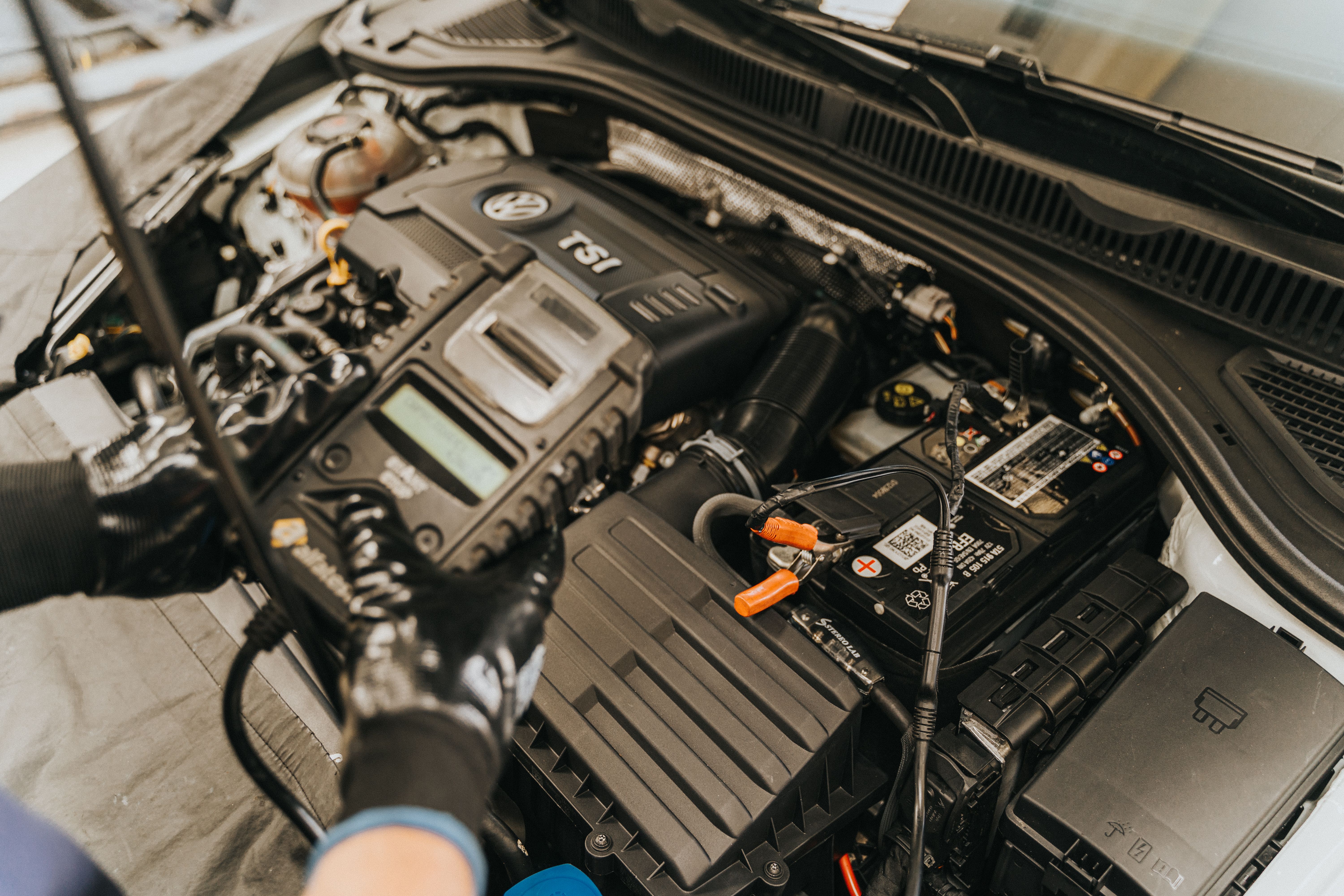 Car battery being tested with diagnostic equipment