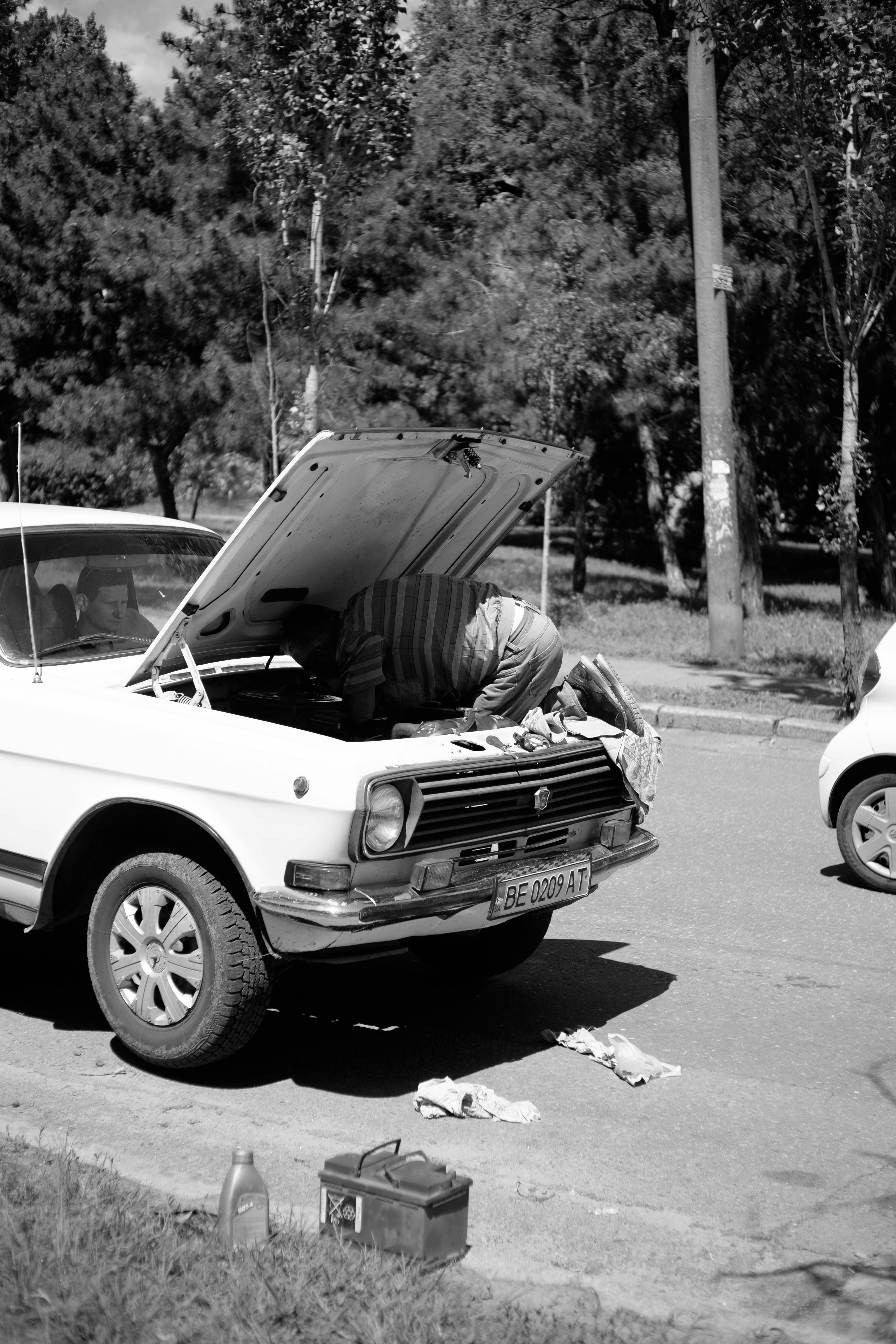 Technician helping with a car battery on site