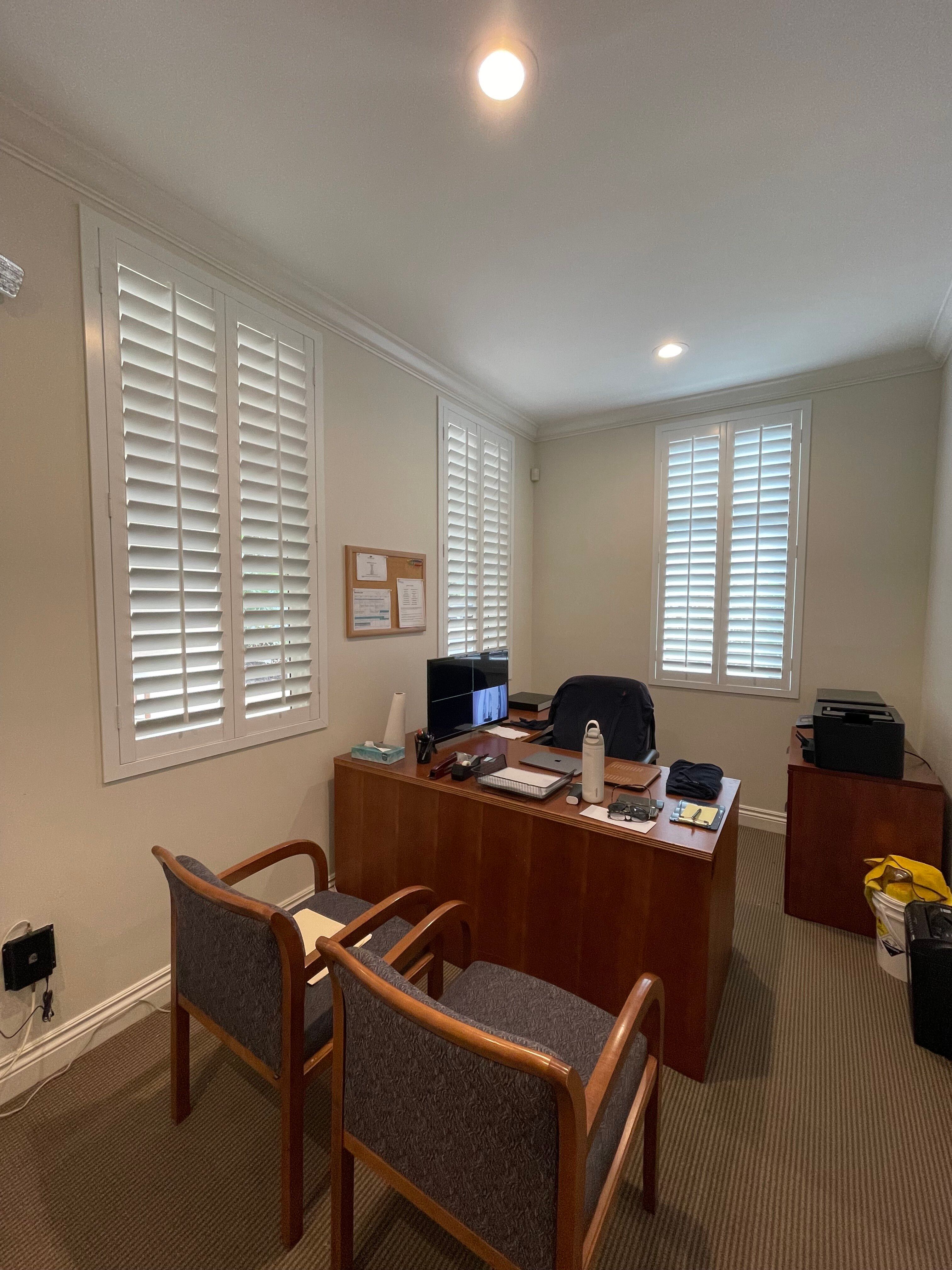 Modern private office suite with desk and chairs